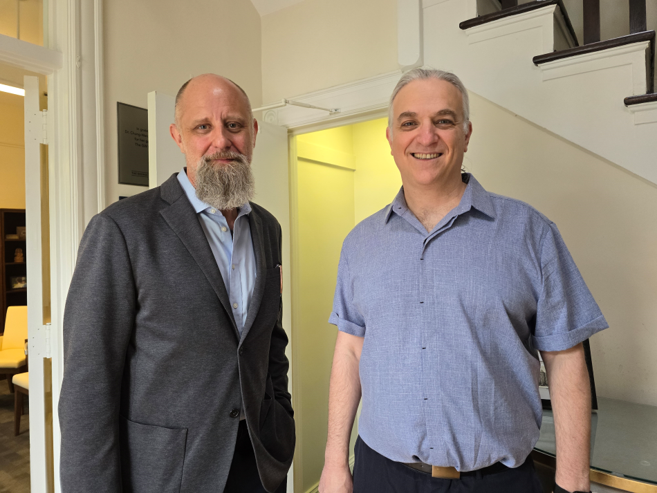 Professor Malone-France and Professor Aviv Standing in Doorway of Department