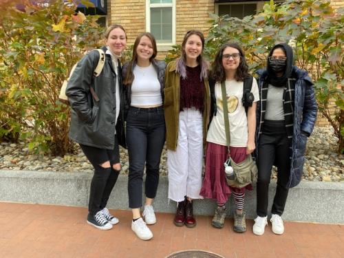 Rows of people on a Zoom screen listening to a lecture