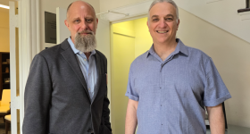 Professor Malone-France and Professor Aviv Standing in Doorway of Department